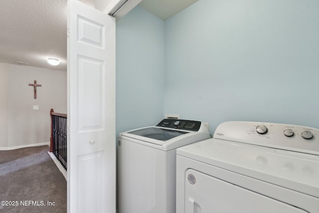 washroom featuring independent washer and dryer, a textured ceiling, and dark colored carpet