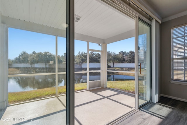 unfurnished sunroom with a water view