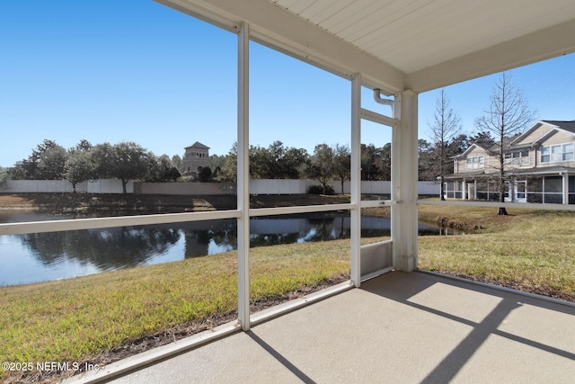 sunroom / solarium featuring a water view