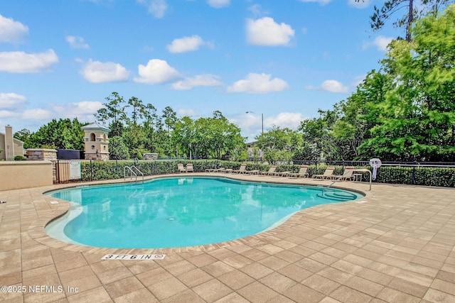 view of swimming pool featuring a patio area