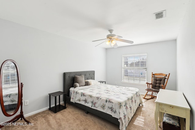 bedroom with baseboards, visible vents, a ceiling fan, and light colored carpet