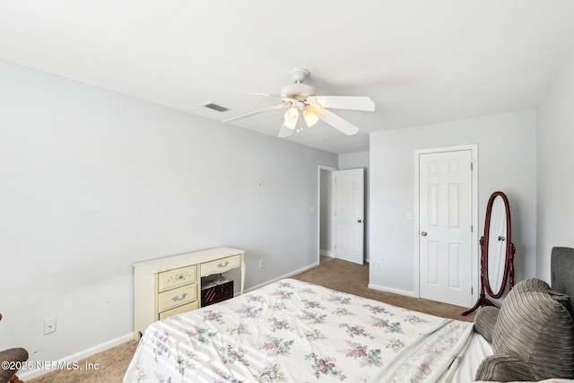 bedroom with a ceiling fan, baseboards, visible vents, and carpet flooring