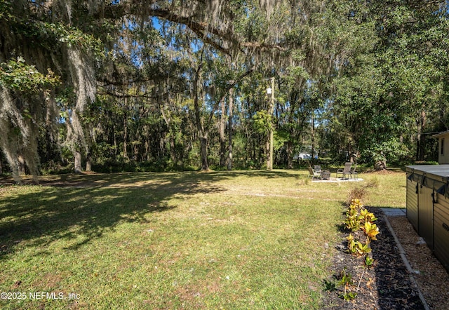 view of yard with an outdoor fire pit