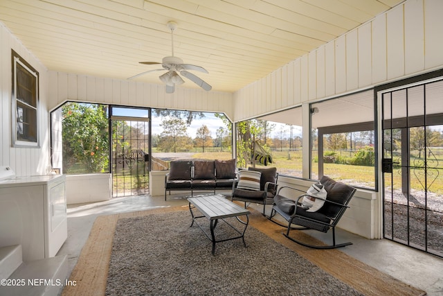 sunroom featuring ceiling fan, washer / dryer, and a wealth of natural light