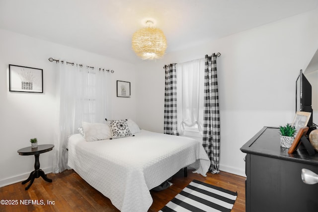 bedroom with dark hardwood / wood-style flooring