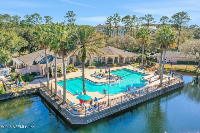 view of pool with a water view and a patio area