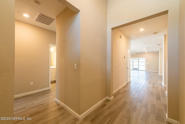 hallway with light wood-type flooring