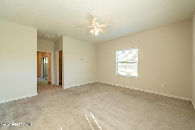 unfurnished room featuring ceiling fan and light colored carpet