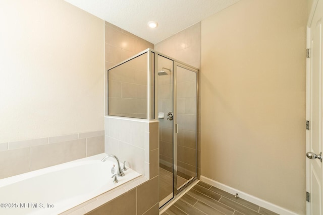 bathroom with shower with separate bathtub