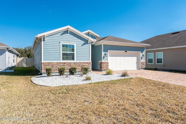 view of front of home with a garage and a front lawn