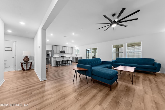 living room featuring ceiling fan and light hardwood / wood-style floors