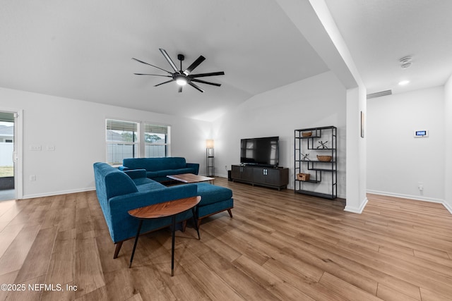 living room featuring ceiling fan, lofted ceiling, and light hardwood / wood-style floors