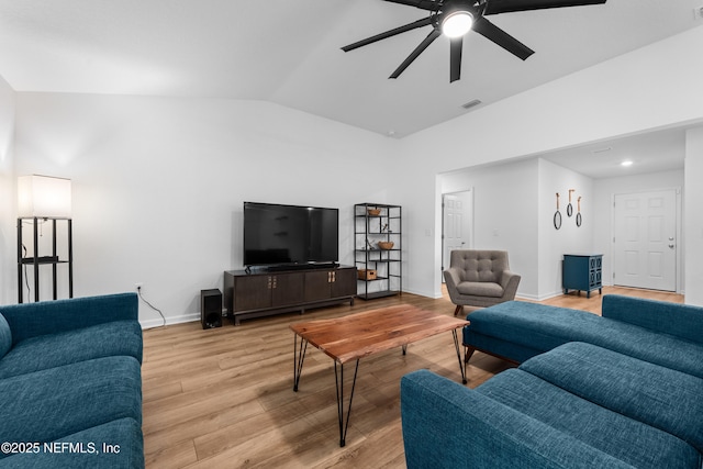 living room with vaulted ceiling, ceiling fan, and light wood-type flooring