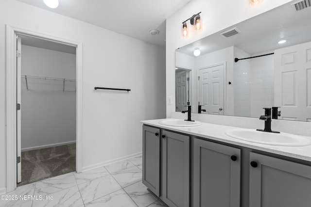 bathroom featuring walk in shower and vanity