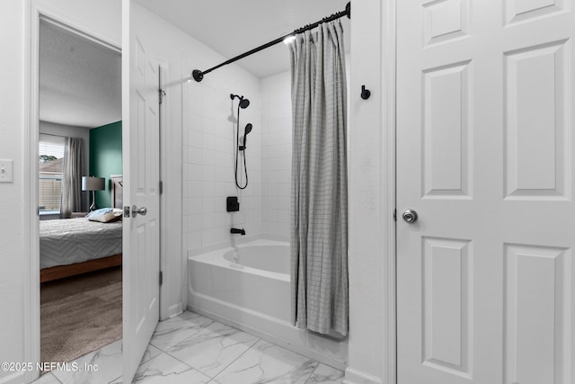 bathroom featuring shower / bath combo and a textured ceiling