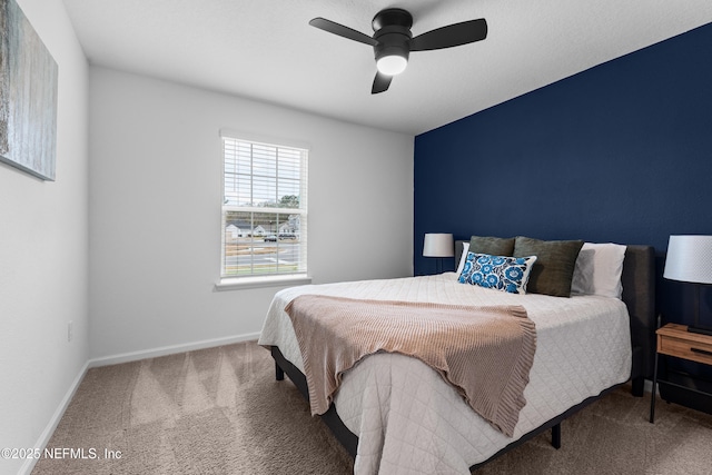 bedroom featuring ceiling fan and carpet