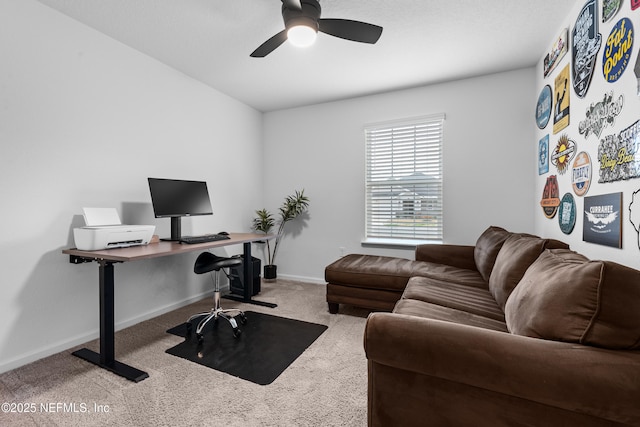 carpeted home office featuring ceiling fan