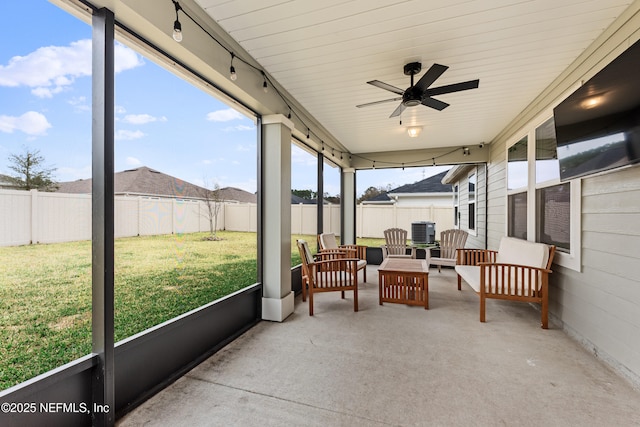 sunroom / solarium with rail lighting and ceiling fan