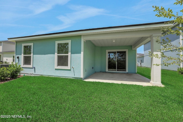 348 Salazar St, Saint Augustine, FL 32095 - back of property featuring a patio area, a lawn, and stucco siding