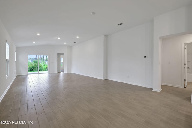 348 Salazar St, Saint Augustine, FL 32095 - spare room with wood finished floors, recessed lighting, and lofted ceiling