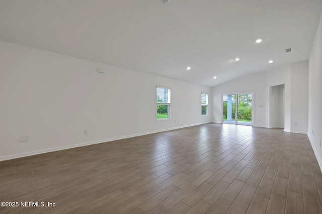 348 Salazar St, Saint Augustine, FL 32095 - empty room with wood finished floors, vaulted ceiling, and recessed lighting