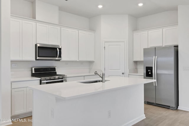 348 Salazar St, Saint Augustine, FL 32095 - kitchen with stainless steel appliances, white cabinets, an island with sink, recessed lighting, and light countertops