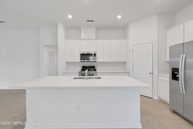 348 Salazar St, Saint Augustine, FL 32095 - kitchen featuring stainless steel appliances, white cabinetry, an island with sink, light countertops, and recessed lighting
