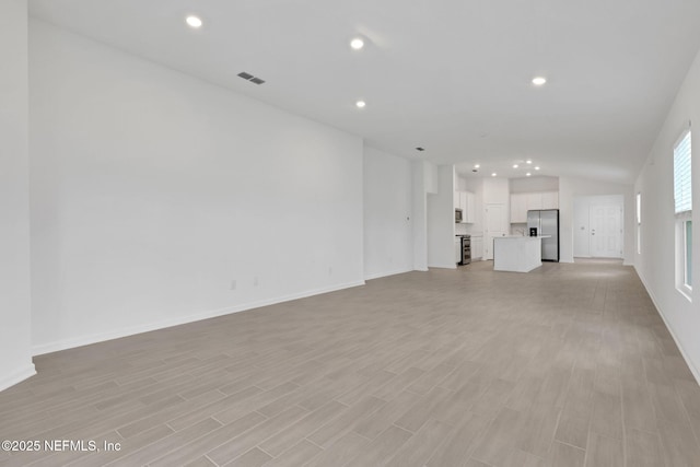 348 Salazar St, Saint Augustine, FL 32095 - unfurnished living room featuring light wood-style floors, recessed lighting, and vaulted ceiling