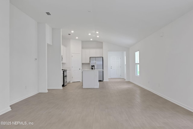 348 Salazar St, Saint Augustine, FL 32095 - unfurnished living room with vaulted ceiling, recessed lighting, and light wood-style floors