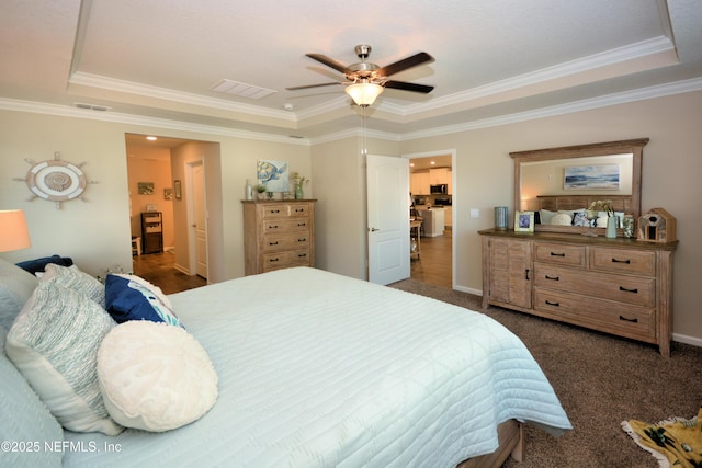 carpeted bedroom featuring crown molding, a raised ceiling, and ceiling fan