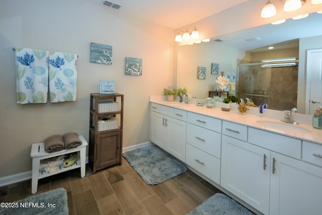 bathroom with an enclosed shower and vanity