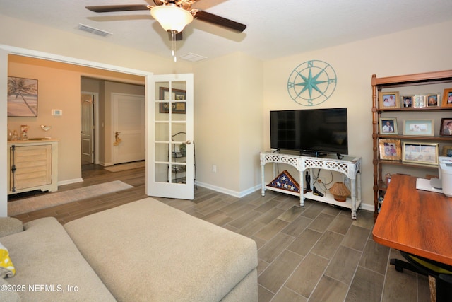 living room featuring french doors and ceiling fan