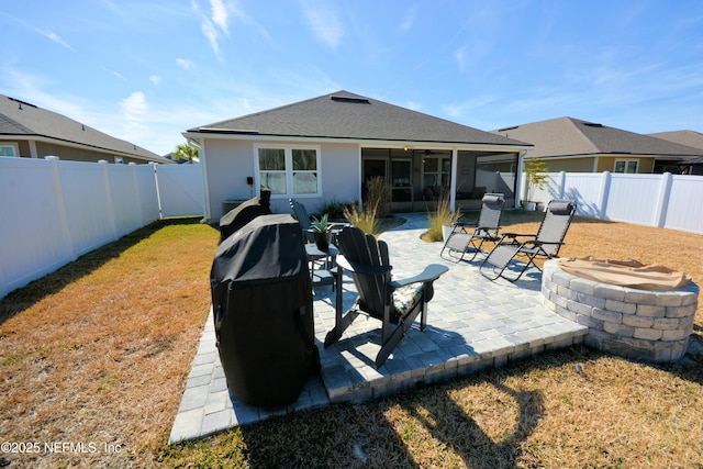 back of house with a patio area and a fire pit