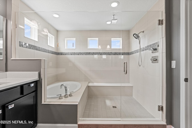 bathroom with vanity and separate shower and tub