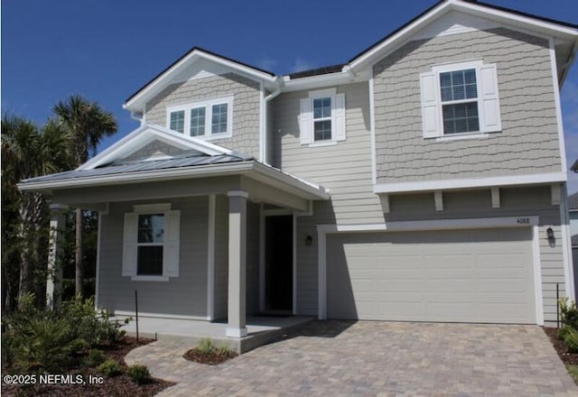 view of front of property with a garage and covered porch