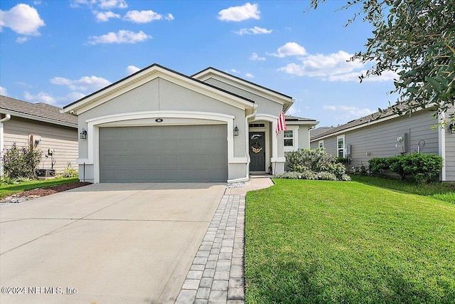 view of front of home with a garage and a front lawn