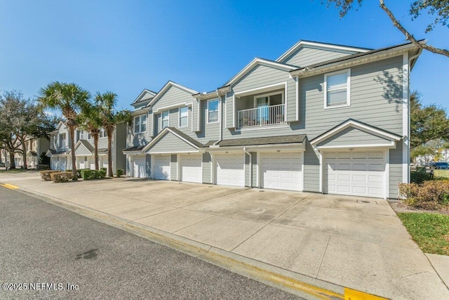 view of front of property featuring a garage and a balcony