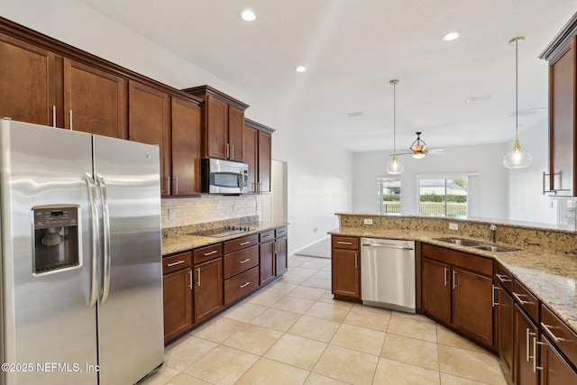4468 Song Sparrow Dr, Middleburg, FL 32068 - kitchen with appliances with stainless steel finishes, pendant lighting, tasteful backsplash, sink, and light stone counters