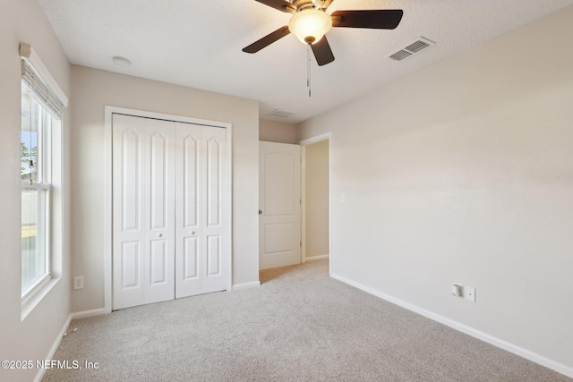 4468 Song Sparrow Dr, Middleburg, FL 32068 - unfurnished bedroom featuring light colored carpet, ceiling fan, and a closet
