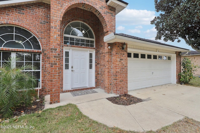 doorway to property with a garage