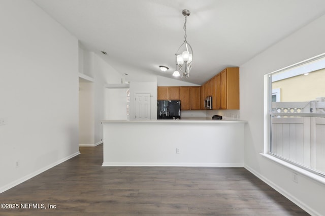 kitchen with decorative light fixtures, lofted ceiling, dark hardwood / wood-style flooring, a notable chandelier, and black refrigerator with ice dispenser