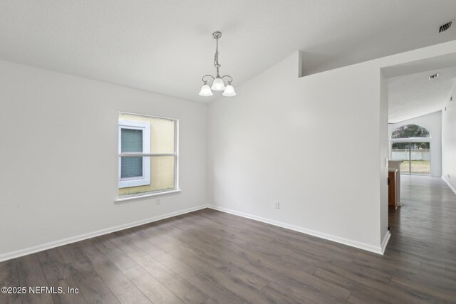 unfurnished room featuring an inviting chandelier, dark wood-type flooring, and vaulted ceiling