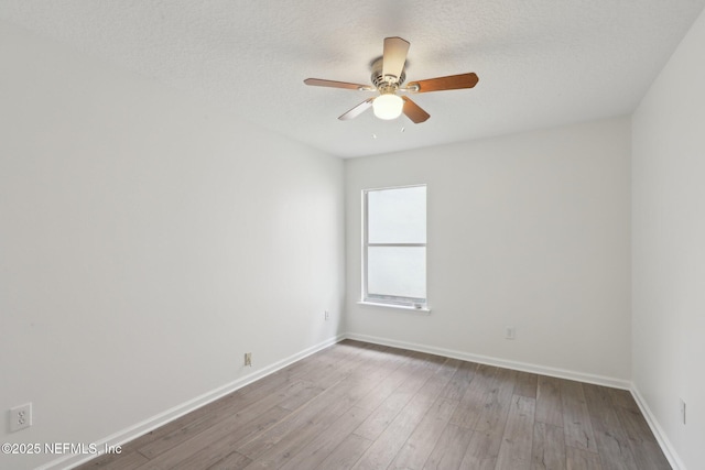 unfurnished room featuring ceiling fan, hardwood / wood-style floors, and a textured ceiling
