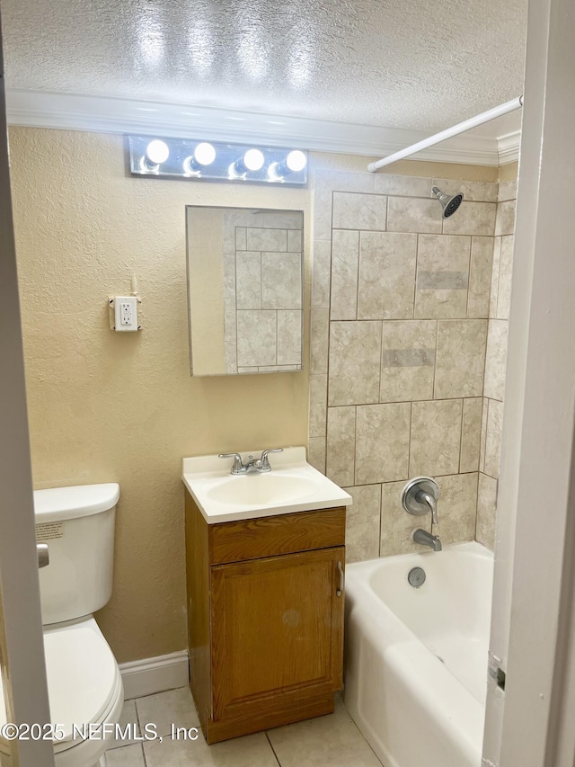 full bathroom with tile patterned floors, toilet, a textured ceiling, vanity, and tiled shower / bath combo