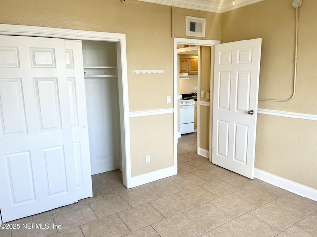 unfurnished bedroom with light tile patterned floors and a closet