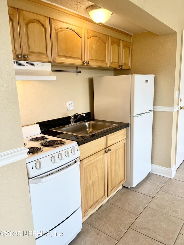 kitchen featuring sink, white appliances, and light tile patterned flooring