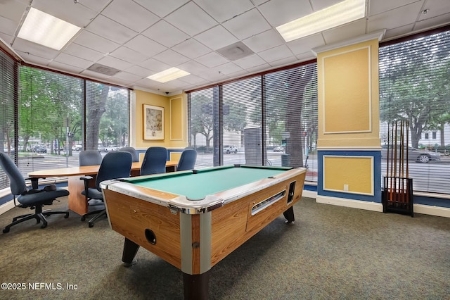 game room featuring dark colored carpet and a drop ceiling