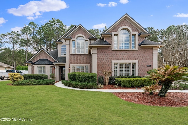 view of front facade with a front lawn and brick siding