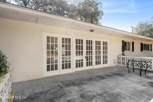 back of property featuring french doors, a patio area, and stucco siding