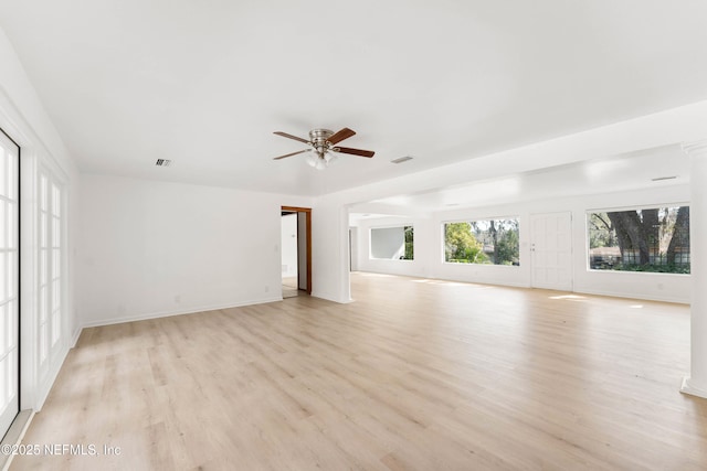 unfurnished living room featuring a ceiling fan, baseboards, visible vents, and light wood finished floors